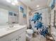 Bright bathroom featuring a white vanity, decorative turtle shower curtain and aquatic themed artwork at 1027 Cedar Bay Ln, Winter Springs, FL 32708