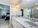 Bathroom vanity with double sinks and doorways leading to shower and bedroom at 1027 Cedar Bay Ln, Winter Springs, FL 32708