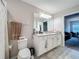 Bathroom with double vanity, tile floors, and views to bedroom and living room at 1027 Cedar Bay Ln, Winter Springs, FL 32708