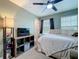 Bright bedroom with ceiling fan, queen bed, media cabinet, and large windows at 1027 Cedar Bay Ln, Winter Springs, FL 32708