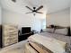 Light-filled bedroom features ceiling fan, dresser and queen bed for a relaxing retreat at 1027 Cedar Bay Ln, Winter Springs, FL 32708