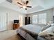 Comfortable bedroom showcases tray ceilings, a ceiling fan, and neutral carpet at 1027 Cedar Bay Ln, Winter Springs, FL 32708