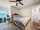 Light-filled bedroom features ceiling fan, queen bed, and desk for a relaxing retreat at 1027 Cedar Bay Ln, Winter Springs, FL 32708