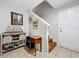 Neutral entryway with tiled floors, wooden stairs, and decorative accents creating a warm welcome at 1027 Cedar Bay Ln, Winter Springs, FL 32708