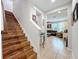 Inviting entryway with hardwood stairs and open view into the living room with tile flooring at 1027 Cedar Bay Ln, Winter Springs, FL 32708