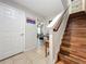 Inviting entryway with wooden stairs, tiled floors, and a view into a bright living space at 1027 Cedar Bay Ln, Winter Springs, FL 32708