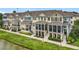Townhomes with screened porches and green lawns along a pond offer a serene exterior with outdoor living spaces at 1027 Cedar Bay Ln, Winter Springs, FL 32708