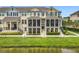 Three-story townhome with screened porches, situated along a pond, offering a relaxing outdoor space and waterfront view at 1027 Cedar Bay Ln, Winter Springs, FL 32708