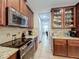 Kitchen features stainless steel appliances, granite counters, stylish cabinetry, and access to other rooms at 1027 Cedar Bay Ln, Winter Springs, FL 32708