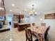 Open-concept kitchen featuring granite counters, stainless steel appliances, and an adjacent dining area at 1027 Cedar Bay Ln, Winter Springs, FL 32708