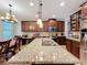 Kitchen island with granite countertops, wooden cabinets, and stainless steel appliances at 1027 Cedar Bay Ln, Winter Springs, FL 32708