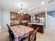 Open-concept kitchen featuring granite counters, stainless steel appliances, and an adjacent dining area at 1027 Cedar Bay Ln, Winter Springs, FL 32708