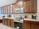 A kitchen showcasing stylish cabinetry, stainless steel appliances, granite counters and decorative tile backsplash at 1027 Cedar Bay Ln, Winter Springs, FL 32708