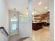 Kitchen and entryway featuring wooden cabinets, an island and pendant lighting at 1027 Cedar Bay Ln, Winter Springs, FL 32708