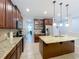 Spacious kitchen featuring a center island, granite countertops, stainless steel appliances, and ample cabinet space at 1027 Cedar Bay Ln, Winter Springs, FL 32708