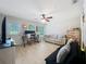 A bright living room featuring new flooring, a ceiling fan, and comfortable seating arrangements at 1027 Cedar Bay Ln, Winter Springs, FL 32708