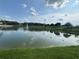 Scenic view of a tranquil pond with a fountain and lush green surroundings at 1027 Cedar Bay Ln, Winter Springs, FL 32708