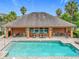 A covered outdoor community pool area with tables and chairs provides a social hub at 1027 Cedar Bay Ln, Winter Springs, FL 32708