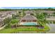 A community pool with an outdoor pavilion, surrounded by lush landscaping and serene lake views at 1027 Cedar Bay Ln, Winter Springs, FL 32708