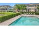 A community pool is surrounded by townhomes and lush greenery, offering a refreshing retreat at 1027 Cedar Bay Ln, Winter Springs, FL 32708