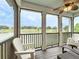 Relaxing screened porch features comfortable seating and scenic views of the tranquil pond at 1027 Cedar Bay Ln, Winter Springs, FL 32708