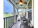 Welcoming screened porch with ceiling fan and seating offers views of the lush surroundings at 1027 Cedar Bay Ln, Winter Springs, FL 32708