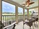 Inviting screened-in porch with ceiling fan and comfortable seating overlooking a serene pond at 1027 Cedar Bay Ln, Winter Springs, FL 32708
