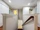 View of the staircase with wood treads, handrail and painted risers that leads to the floor below at 1027 Cedar Bay Ln, Winter Springs, FL 32708