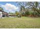 Large backyard with a pool, play set, mature trees, and well-manicured lawn at 103 Cherry Hill Cir, Longwood, FL 32779