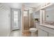 Bathroom featuring a glass-enclosed shower, tiled floors, and door to the exterior at 103 Cherry Hill Cir, Longwood, FL 32779