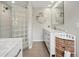 Bright bathroom with a glass block shower, vanity with counterspace, and decorative storage baskets at 103 Cherry Hill Cir, Longwood, FL 32779