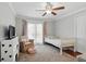 Cozy bedroom with a twin bed, plush chair, and carpeted floors, creating a welcoming space at 103 Cherry Hill Cir, Longwood, FL 32779
