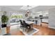 Bright dining area open to the kitchen, features a large table, hardwood floors, and access to outdoor living area at 103 Cherry Hill Cir, Longwood, FL 32779