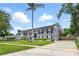 Spacious two-story home with long driveway, lush lawn, and symmetrical window and shutter design at 103 Cherry Hill Cir, Longwood, FL 32779