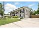 Two-story home with long driveway, lush lawn, and symmetrical window and shutter design at 103 Cherry Hill Cir, Longwood, FL 32779
