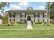 Charming two-story home with a manicured lawn and decorative shutters, exudes classic curb appeal at 103 Cherry Hill Cir, Longwood, FL 32779