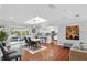 Inviting living room with hardwood floors, skylight, and access to a screened patio at 103 Cherry Hill Cir, Longwood, FL 32779
