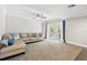 Spacious living room boasting a comfortable sectional sofa and French doors to the patio at 103 Cherry Hill Cir, Longwood, FL 32779