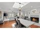 Open concept living room features hardwood floors, fireplace, skylight, and neutral paint scheme at 103 Cherry Hill Cir, Longwood, FL 32779