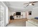 Bright living room with ceiling fan, hardwood floors, entertainment center, and French doors at 103 Cherry Hill Cir, Longwood, FL 32779