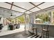 View of the covered patio with lounge area overlooking the pool and backyard at 103 Cherry Hill Cir, Longwood, FL 32779