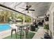 Covered patio featuring outdoor seating, string lights, and overlooking the backyard pool at 103 Cherry Hill Cir, Longwood, FL 32779