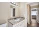 Bright bathroom featuring a granite vanity top and a classic mirror with decorative lighting at 108 N Truett St, Leesburg, FL 34748