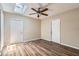 Room with modern floors, ceiling fan, skylight, and two doors at 108 N Truett St, Leesburg, FL 34748
