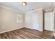 This bedroom features wood-look floors, a window, a closet, and neutral paint at 108 N Truett St, Leesburg, FL 34748