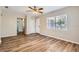 Inviting bedroom featuring wood flooring, a ceiling fan, and a bright window at 108 N Truett St, Leesburg, FL 34748