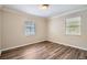 Bedroom with wood-look flooring, window, and decorative crown molding and trim at 108 N Truett St, Leesburg, FL 34748