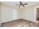 Room features modern floors, ceiling fan and exit door at 108 N Truett St, Leesburg, FL 34748
