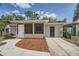 Charming single-story home featuring a screened porch and a tidy front yard with mulch at 108 N Truett St, Leesburg, FL 34748