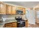 Modern kitchen featuring stainless steel appliances and granite countertops near a bathroom at 108 N Truett St, Leesburg, FL 34748
